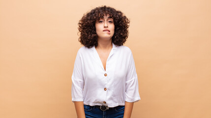  looking puzzled and confused, biting lip with a nervous gesture, not knowing the answer to the...