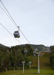 Cable car in the air in the forest.