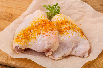 Raw chicken thigh with spices