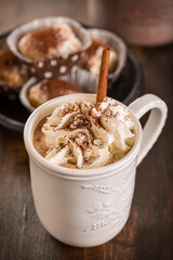 Cup of hot cocoa with whipped cream and small Christmas stollen cookies