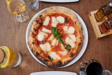 Close up view of a Margherita Neapolitan style pizza with buffalo mozzarella, tomato sauce and basil