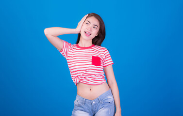 Portrait of beautiful asia young woman, on blue color background with copy space. Human face...