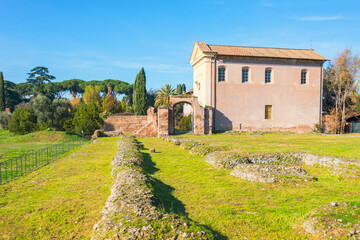 Fototapeta na wymiar Ancient Rome House and meadow with garden, remains in the meadow of the Roman Forum.