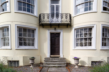 the entrance to a large Victorian house with bay windows either side of the front door