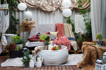 gazebo interior in folk style with pillows and coffee