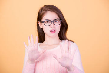 Portrait of beautiful asia young woman, on yellow color background with copy space. Human face expressions, emotions feelings, body language,beauty and fashion concept.