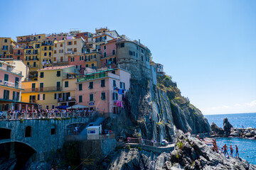 Fototapeta na wymiar Village of Manarola, Cinque Terre coast of Italy. magnificent seen from the Italian coast, Manarola is a small town in Liguria, in the north of Italy - aerial view with a drone - travel concept