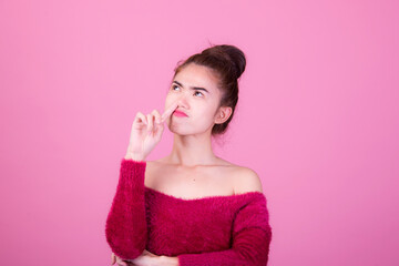 Portrait of beautiful asia young woman, on pink color background with copy space. Human face expressions, emotions feelings, body language,beauty and fashion concept.