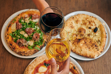 Pizza, a glass of light and dark wine