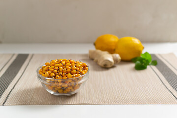 Sea-buckthorn in a glass bowl. Ingredients for sea buckthorn tea. Autumn drink. Selective focus. Copy space.