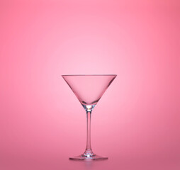 empty martini cup isolated on pastel pink background