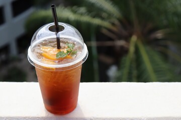Melon iced tea in a clear plastic glass
