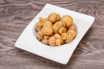 Pickled champignons in the bowl