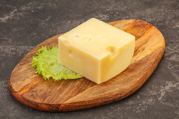 Emmental cheese over wooden board