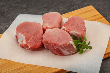 Raw pork medallion served rosemary