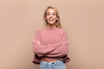  looking like a happy, proud and satisfied achiever smiling with arms crossed