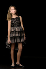 Fototapeta na wymiar Beautiful young teen girl studio photo on black background