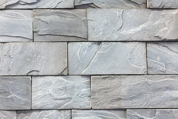 Seamless texture of white decorative stacked stone, natural stone cladding. brick background. close up. Background