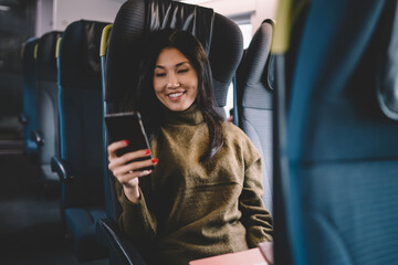 Cheerful Asian woman making video call in bus © BullRun