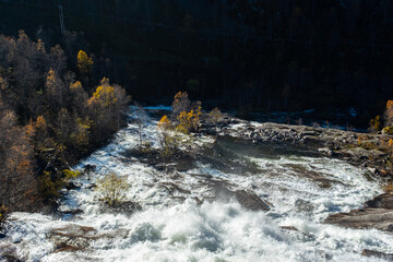 Autumnal Landscape in Norway with Flowing River