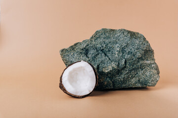 Half a coconut on a stone background close-up