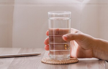 Woman holding a glass of the water for health.