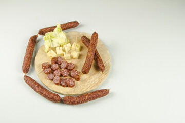 South Tyrolean snack dish such as Tyrolean smoked sausage on a wooden cutting board accompanied by kaminwurz and paarl type bread