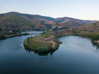 Douro wine valley region, Portugal. Vineyards landscape with beautiful farm. Tourist attraction and travel destination. Drone aerial top view. Bend shape river.
