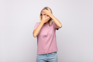  covering face with both hands saying no to the camera! refusing pictures or forbidding photos