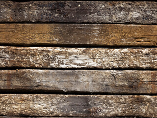 Rustic, textured, timber sleepers piled on top of each other as a background