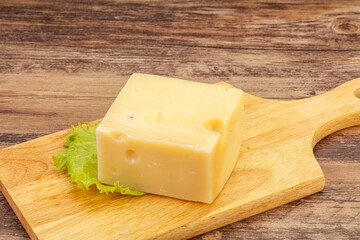 Emmental cheese over wooden board