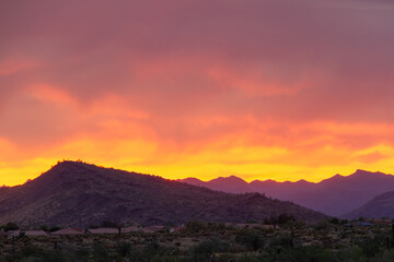 A dramatic cloudy sunset in the desert of Arizona with mountains.