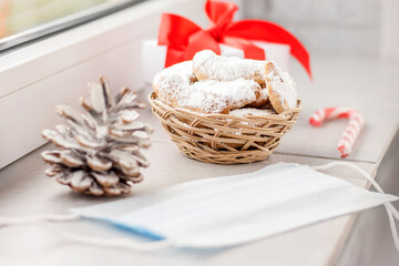 Traditional Austrian and German crescent-shaped Christmas pastries - Vanillekipferl - on the windowsill near the window with Christmas decorations