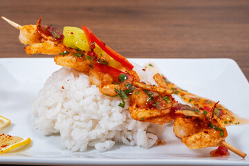 Tasty grilled shrimps with spices and rice served on a plate