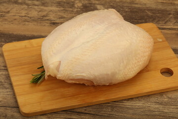 Raw whole chicken breast with skin