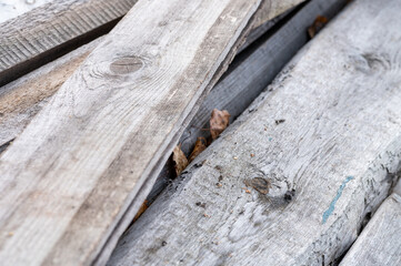 A pile of old boards suitable for the furnace, close-up, selective focus.
