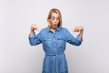  with open mouth pointing downwards with both hands, looking shocked, amazed and surprised