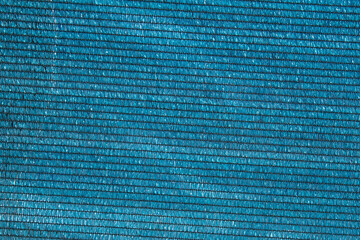 Shiny cobalt blue plastic mesh with black thread lines and geometric patterns as a hypnotic...