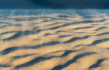 Wind in the sand dunes of Huacachina at sunset, Peru.