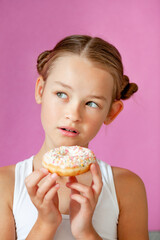 cute girl holding an appetizing glazed donut in her hands