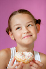 cute girl holding an appetizing glazed donut in her hands