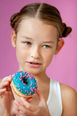 cute girl holding an appetizing glazed donut in her hands