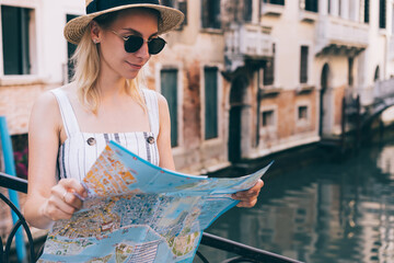 Focused woman reading paper map