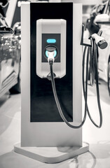 The power supply plugged into an electric car to charging a battery at the charging station