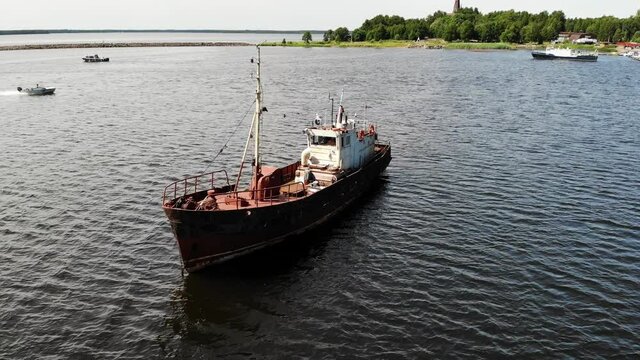 old fishing ship in a bay on the water. Aerial Drone is rotating circular flight