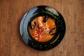 Seafood soup on the wooden table
