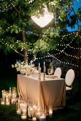 festive wedding table setting for bride and groom with chandelier
