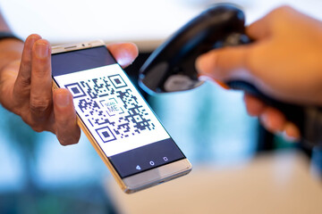barcode scanner scanning qr code on smartphone for e-payment, online shopping, cashless technology...