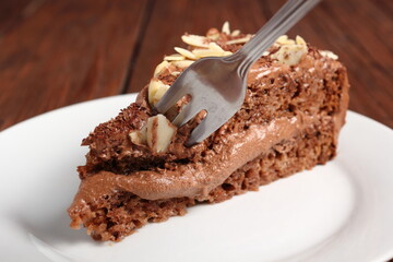 Chocolate sandwich cake garnished with flaked almonds