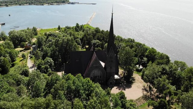 Old nice catholic church. on the shore of lake or sea. Primorsk Koivisto, aerial